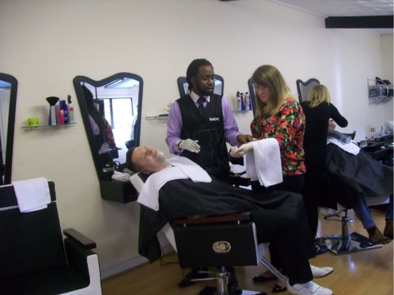 MK training a professional in a salon environment